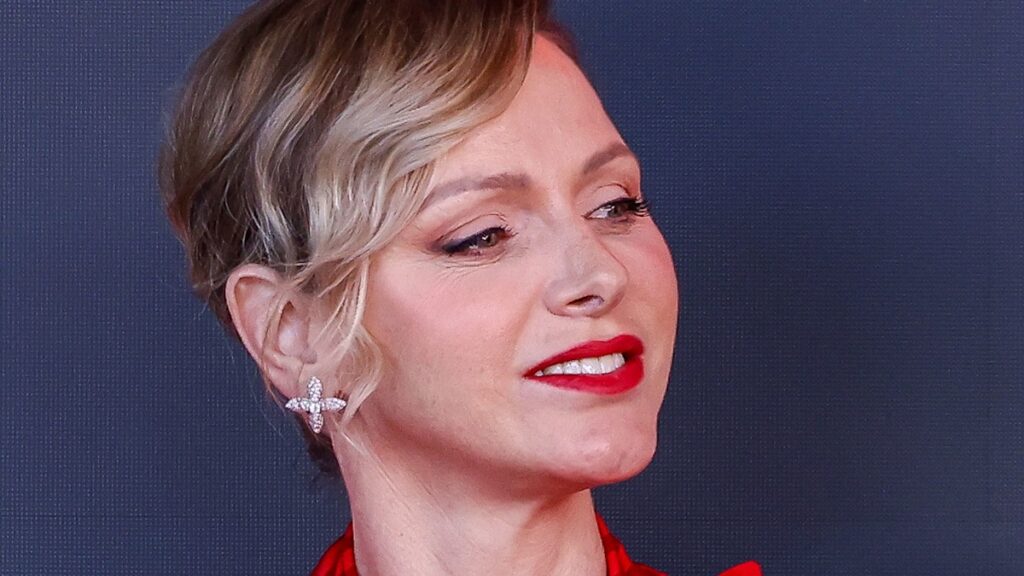 Princess Charlene is a scarlet siren in gorgeous form fitting gown