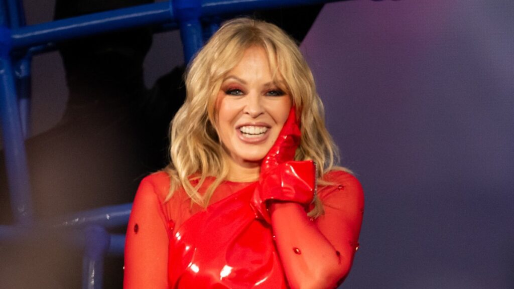 Kylie Minogue turns up the festive fun in fire red latex dress